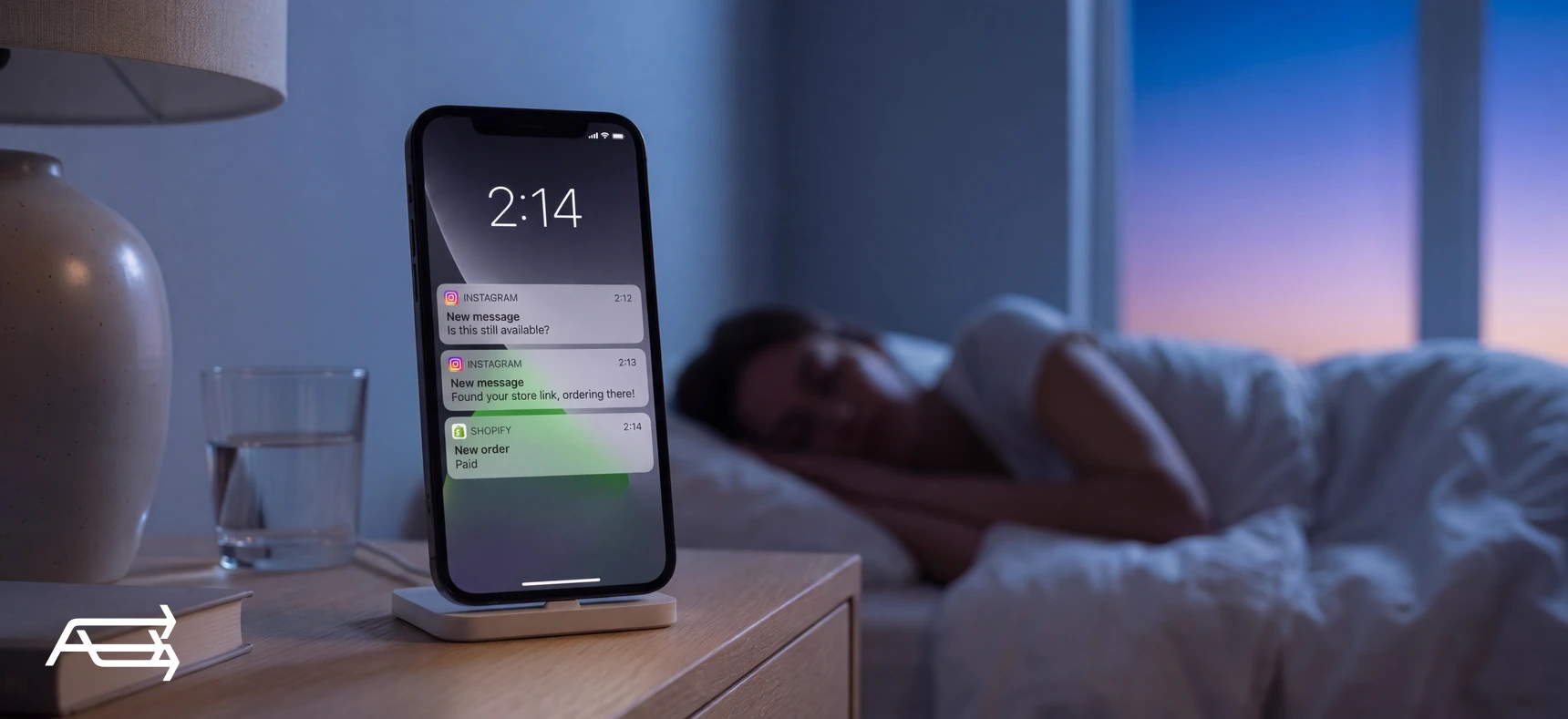 A phone beside a sleeping store owner at 2:14 am, showing two Instagram messages and a paid Shopify order