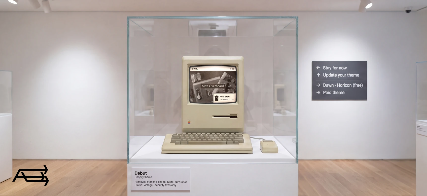 The Debut theme on an old Macintosh in a museum case, labelled vintage, beside a sign with four options: stay, update, free theme, paid theme